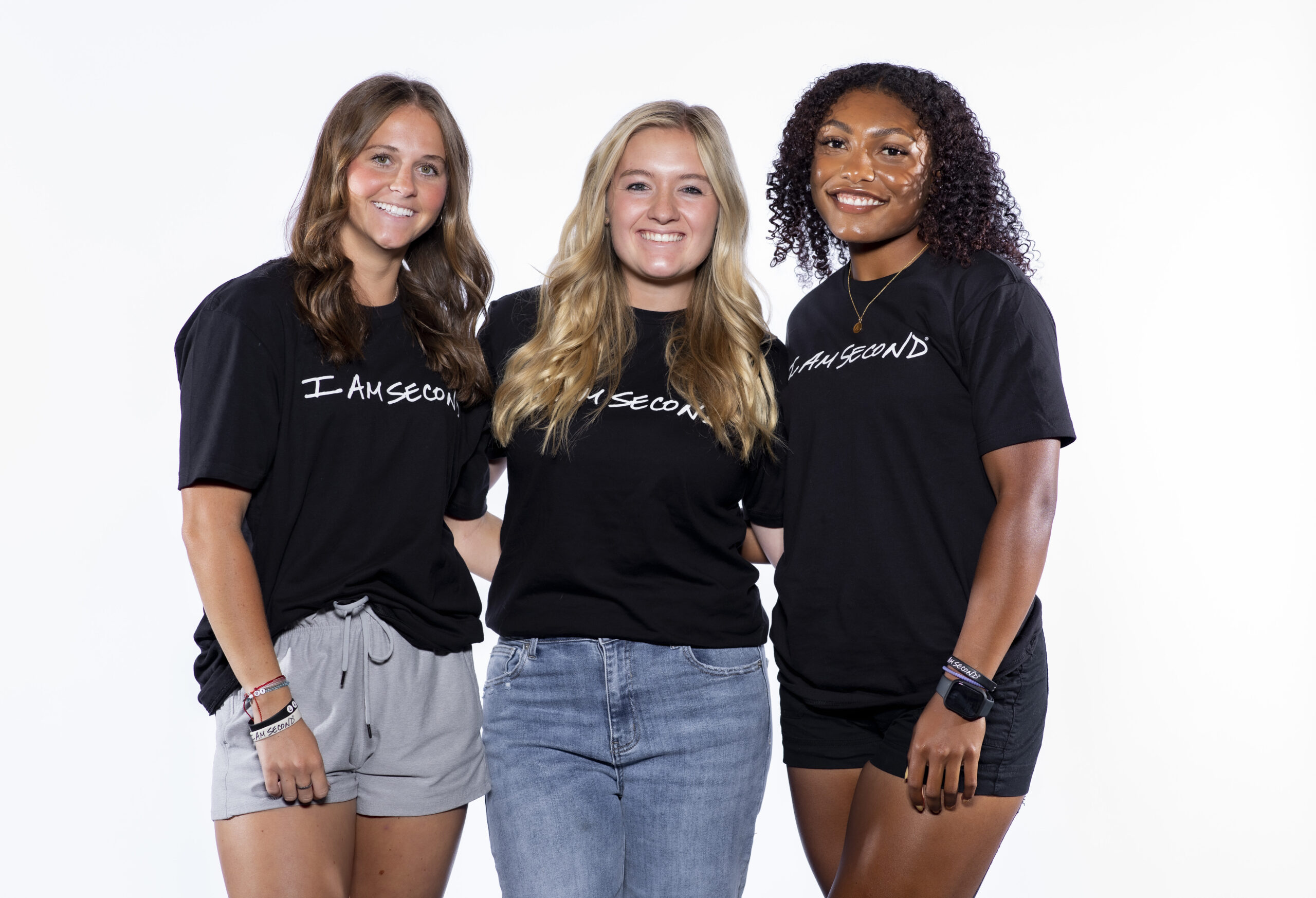 3 Girls wearing an IAS shirt