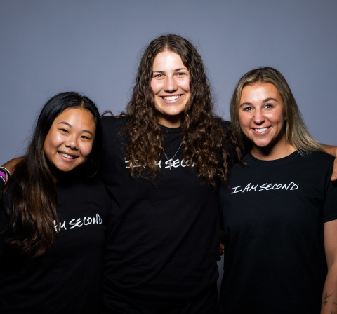 A photos of Ashley Trierweiler with her arms on the shoulders of Ally Chin and Ashley Prange.